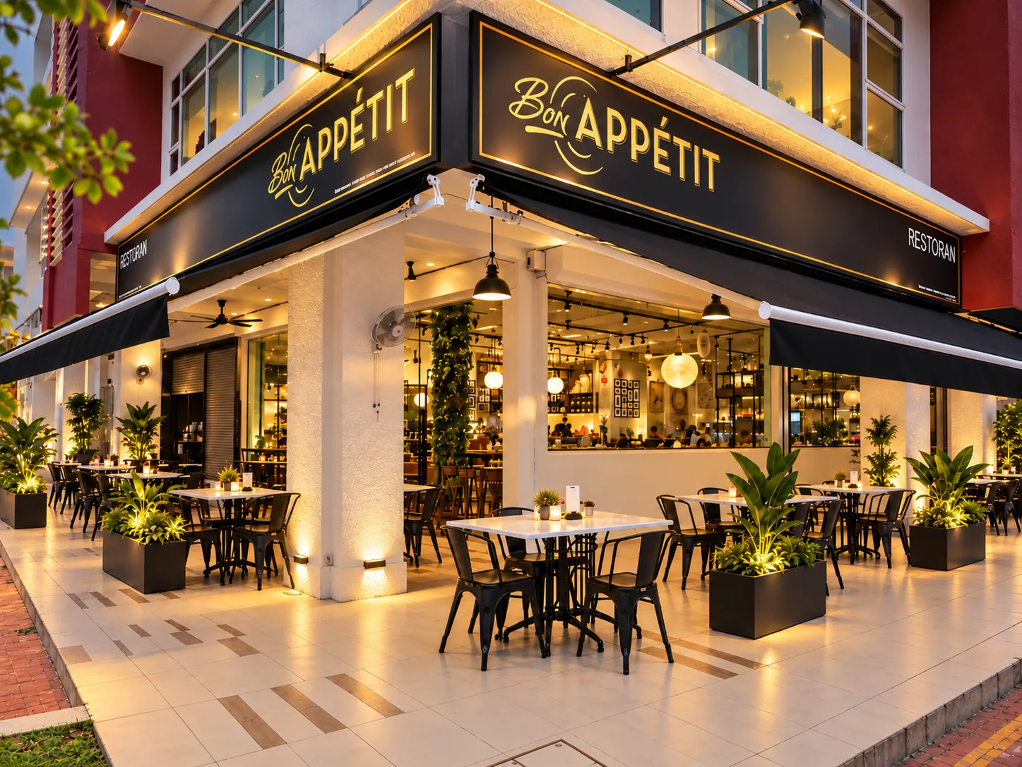 The Bon Appétit corner frontage at Oasis Square with outdoor tables at dusk